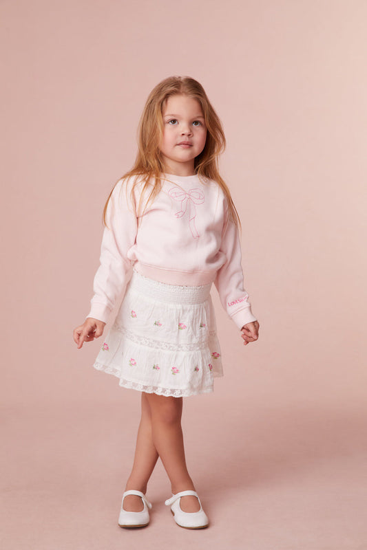 Girls skirt embroidered with small rosebuds all over, an elasticated waistband and lace details all over.