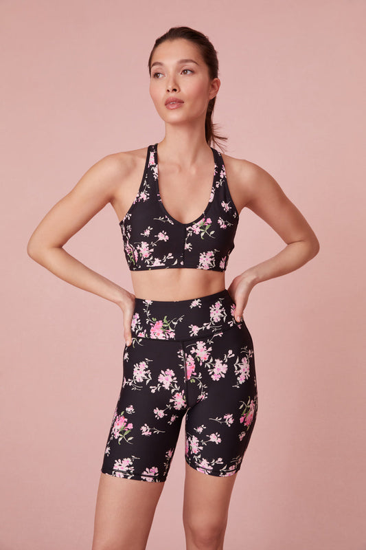 Black biker shorts with a pink floral bouquet print.