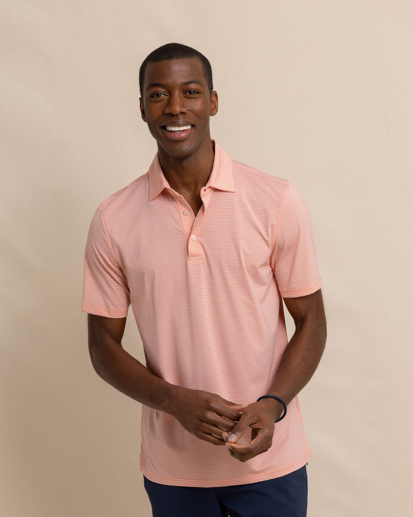 The front view of the Southern Tide brrr-eeze Baytop Stripe Performance Polo by Southern Tide - Desert Flower Coral