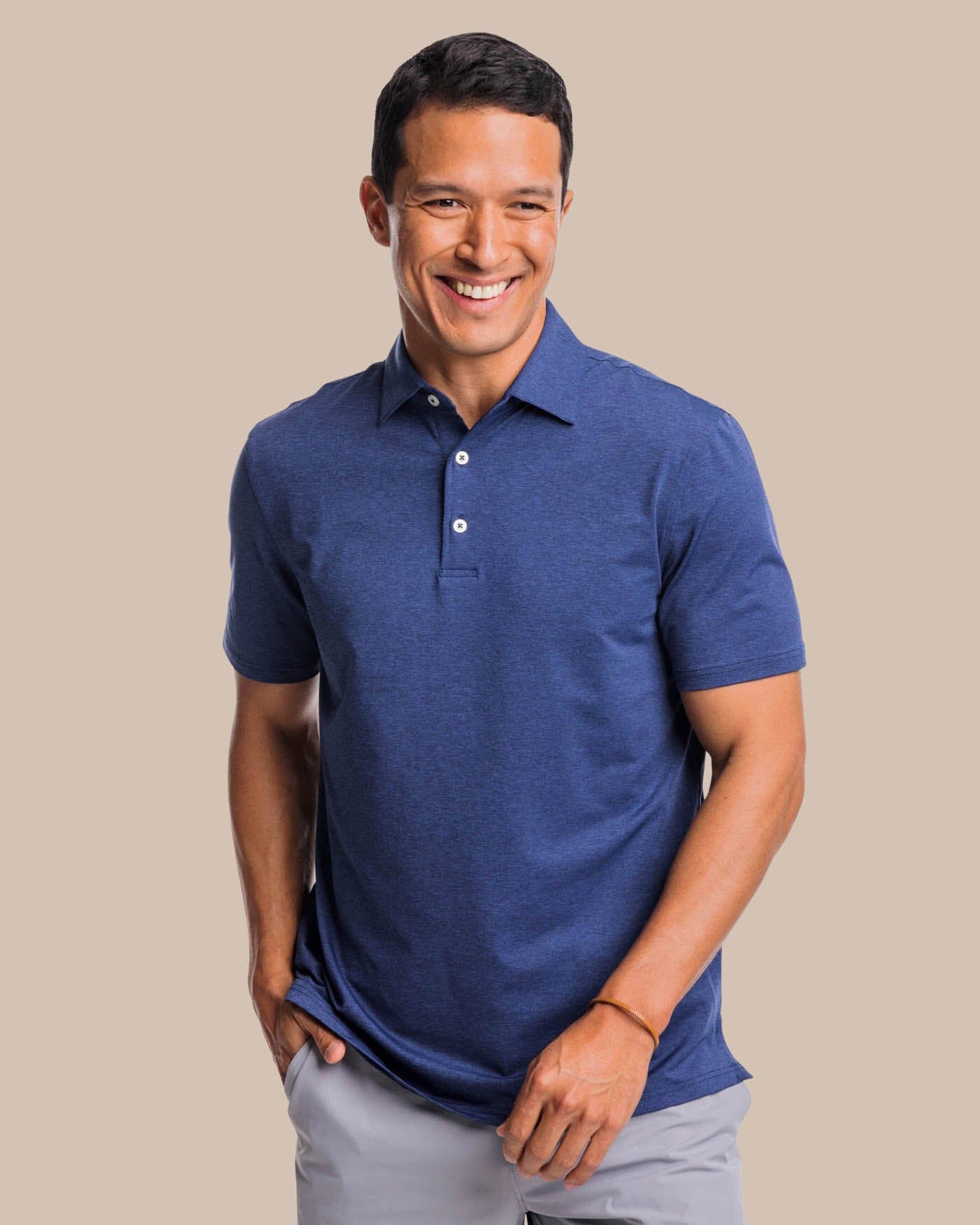 The front view of the brrr掳庐-eeze Heather Performance Polo Shirt by Southern Tide - Heather Nautical Navy
