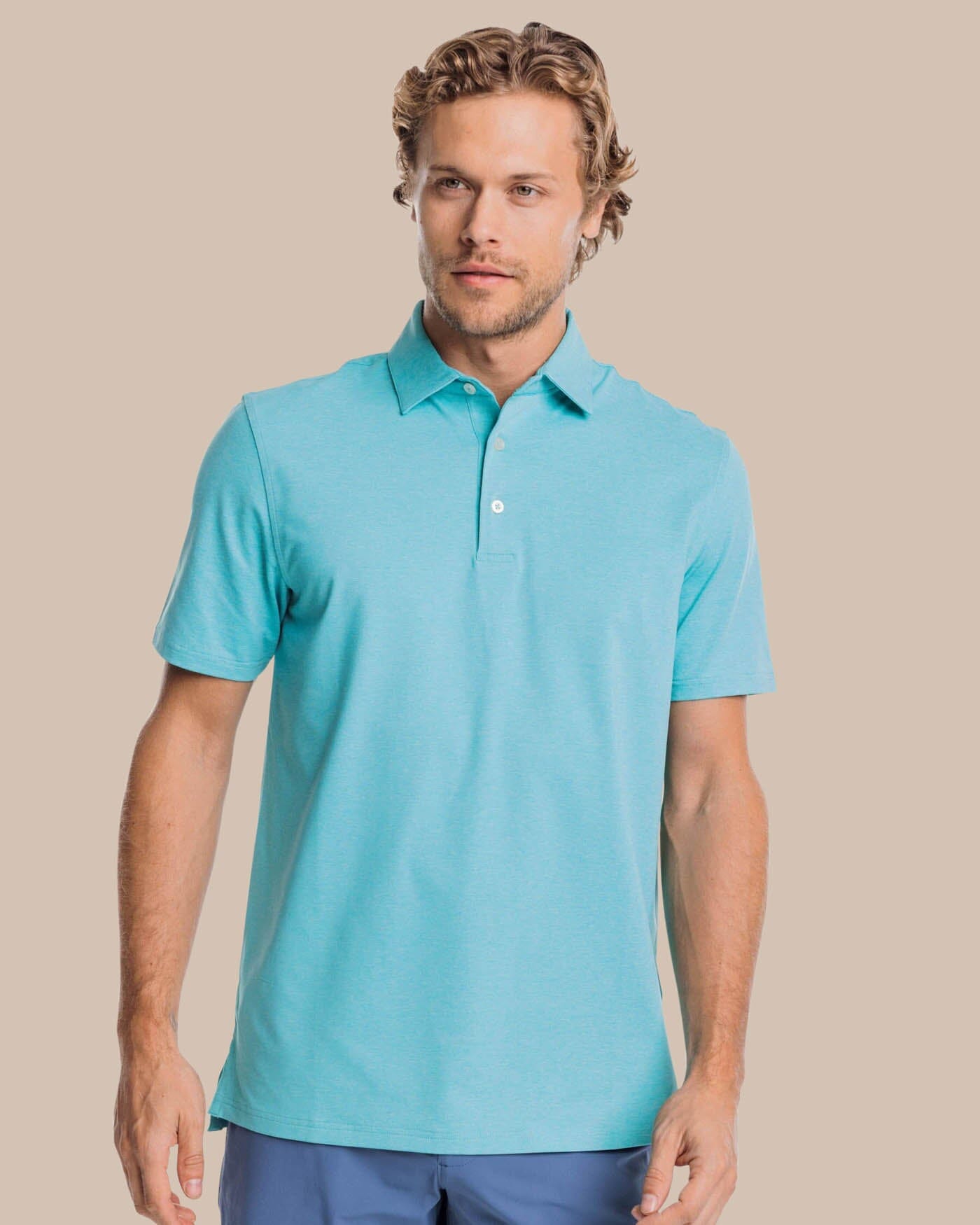 The front view of the brrr掳庐-eeze Heather Performance Polo Shirt by Southern Tide - Heather Tidal Wave